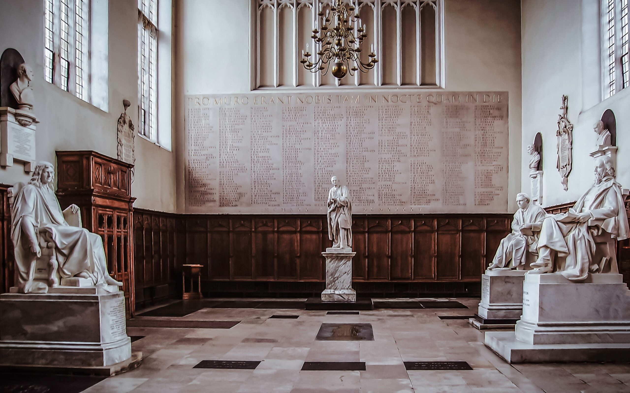 White marble statues of various philosophers at Cambridge University, image used for philosophy audiobooks and mediocrates