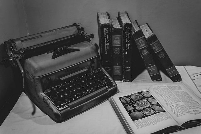 writing station with vintage typewriter and books stacked/laying open. Used as image in classical literature audiobooks post.